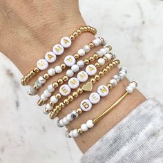 🔹 Design the personalized word bracelet that you have always wanted! These stacking mama bracelets can be personalized so you can get exactly what you want. 🔹They are made with 4mm howlite gemstones beads, 18k gold plated beads, 18k gold filled beads, sterling silver beads or rose gold beads and then strung together with a double - strung strong elastic cord. 🔹Please add each bracelet style separately to your cart. They will be sent to you as a stack. If you want all seven bracelets, please choose the option for all seven bracelets, otherwise you will receive the single styles that you purchased. 🔹Each custom beaded bracelet stack is packed in a gift box wrapped in organza ribbon and a handwritten message can also be included. It makes the perfect gift for yourself or for Christmas, a Personalized Letter Beads Bracelets, Personalized Inspirational Stretch Bracelet, Personalized Inspirational Stretch Bracelet For Everyday, Inspirational Personalized Stretch Bracelet, Personalized Stretch Bracelet For Friendship, Personalized Meaningful Beaded Bracelets As Gift, Personalized Meaningful Stretch Bracelet For Everyday, Meaningful White Adjustable Beaded Bracelets, Everyday Inspirational Name Bracelet With Round Beads