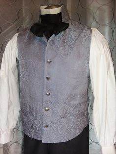 This item is made-to-order and will ship within 14 days of purchase Classic English Regency mans waistcoat with a high standing collar, 7 buttons , 2 functioning pockets at waist, back belt with eyelet lacing, and is fully lined. Pair it with an English Regency Shirt in white cotton, for that perfect Mr. Darcy look! Click here for more info on the shirt: https://www.etsy.com/listing/86516151/mans-english-regency-and-18th-century? Color and fabric selections vary upon availability - please specif Elegant Wedding Vest With Buttons, Sleeveless Vest With Buttons For Wedding, Fitted Wedding Vest With Buttons, Fitted Vest With Buttons For Wedding, Steampunk Formal Sleeveless Vest, Formal Steampunk Sleeveless Vest, Formal Sleeveless Steampunk Vest, Gothic Fitted Vest With Buttons, Steampunk Sleeveless Vest With Buttons