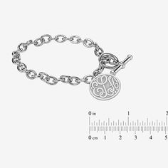 Wear this monogram charm bracelet as a constant reminder of the bond you share with someone special. Initials will appear exactly as entered. Must be three letters, center initial will be enlarged. Made in America.Metal: Rhodium-plated sterling silverClosure: ToggleDimensions: 7¼" long circular chainPendant Size: 20mmPersonalize: Up to 3 script initials. Initials will appear exactly as entered; center initial will be enlargedCare: Wipe CleanCountry of Origin: USJewelry photos are enlarged to sho Classic Personalized Charm Bracelet, Engraved Classic Charm Bracelet, Hypoallergenic White Gold Charm Bracelet, Hypoallergenic Charm Bracelet For Personalized Gift, Engraved Stainless Steel Charm Bracelet, Elegant Sterling Silver Initials Name Bracelet, Adjustable Initials Charm Bracelet For Personalized Gift, Personalized Monogram Silver Bracelet, Personalized Silver Charm Bracelet With Initials