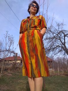 "Vintage 80s high waisted shirtdress. Colorful short sleeve buttoned up midi dress. Has two front pockets on the bodice and two side pockets. Elastic waist. Bronze colour metal buttons. Marked as USA 10 size. From shoulder to shoulder 20\" 51cm Bust 40\" 102cm Waist 38\" 71cm Hips 40\" 102cm Sleeve length 9\" 23cm Length 47\" 119cm In good vintage condition" Vintage Knee-length Midi Dress For Summer, Knee-length Summer Vintage Dress, Retro Mid-length Summer Dresses, Retro Short Sleeve Midi Dress For Spring, Vintage Short Sleeve Midi Dress For Day Out, Vintage Mid-length Midi Dress For Summer, Vintage Style Mid-length Summer Midi Dress, Vintage Style Mid-length Midi Dress For Summer, Fitted Retro Midi Dress For Day Out