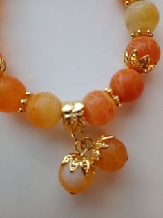 10mm orange crackle agate with bead bobble charms7.78 inch stretch bracelet Cheap Orange Beaded Bracelets, Cheap Orange Bead Bracelets, Adjustable Orange Agate Bracelet, Adjustable Orange Agate Bracelets, Orange Stretch Bracelet With 8mm Beads, Handmade Orange Agate Beaded Bracelets, Orange Stretch Bracelet With Large Beads As Gift, Adjustable Orange Stretch Bracelet With 8mm Beads, Gift Orange Stretch Bracelet With Large Beads