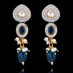 Dive into the symphony of blue elegance designed to make you feel like royalty! Adorn this one-of-a-kind jewelry set mesmerizing with radiant sapphire stones that beautifully complement different shades of blue beads along with sparkling CZ stones and delicate kundan accents with white and green moti, creating a spellbinding glow. The set includes a necklace and a pair of straight drop earrings. Approximate earrings length is 2". Pair our stunning Mohini Set with Nirali Bangles. Please click on Blue Cubic Zirconia Jewelry For Celebration, Fusion Style Blue Kundan Jewelry, Blue Kundan Necklace For Reception Festivities, Blue Kundan Necklace For Festive Reception, Exquisite Hand Set Blue Jewelry, Blue Kundan Necklace For Reception And Festive Occasions, Blue Bollywood Jewelry For Reception, Blue Stone Work Jewelry For Celebration, Exquisite Hand-set Blue Jewelry