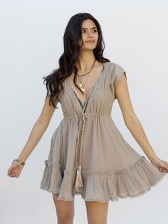 Beige Mini Dress With Tie Straps, Summer Mini Dress With Tie Waist For Brunch, Beige Summer Dress With Drawstring, Mini Dress With Drawstring For Brunch, Casual V-neck Mini Dress With Tie Fastening, Brunch Mini Dress With Drawstring, Beige Drawstring Dress For Summer, Beige Drawstring Summer Dress, Summer Beige Drawstring Dress