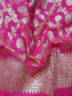 pink and gold brocaded banaram saree with floral design on the border