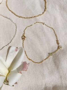 + DAISY CHAIN FRIENDSHIP BRACELET +Tiny Natural Pearls surround a 14ky Gold-filled bead to make this daisy chain bracelet along with a three 2mm 14ky gold-filled beads, a pearl, and Peridot rondelle or you can keep it simple with just one daisy beads in center. Its a melody of stones and pearls along your wrist. A perfect and sweet bracelet that is an upscale friendship bracelet. The pearls are Natural fresh water pearls that should not be exposed to water or liquids. Tiny Ball beads and chain a Delicate Gold Bracelet With Chain As Gift, Dainty Chain Bracelet As Gift, Dainty Pearl Chain Bracelet, Dainty Chain Bracelet With Pearl Charm, Handmade 14k Gold Dainty Bracelet, Delicate 14k Gold Filled Bracelet For Gift, Dainty 14k Gold Filled Chain Bracelet For Gift, Handmade Dainty 14k Gold Bracelet, Delicate 14k Gold Filled Bracelet As Gift