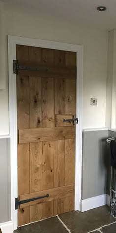 a kitchen with a wooden door and tile floor