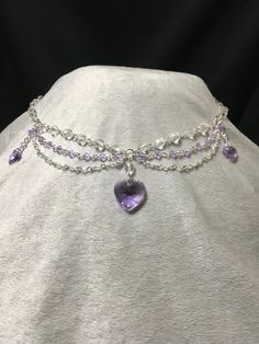 Elegant and dainty necklace made using violet Swarovski bicone beads and featuring three violet Swarovski heart pendants. Necklace is 19.5 inches long, with a lobster clasp closure. Crystal Heart Cut Jewelry With Heart Charm, Elegant Heart Beads Choker, Crystal Jewelry With Heart Charm For Valentine's Day, Valentine's Day Crystal Jewelry With Heart Charm, Crystal Double Heart Necklaces For Wedding, Heart Cut Beaded Necklaces For Party, Elegant Heart Shaped Rhinestone Jewelry, Heart Cut Necklaces With Heart Beads For Party, Elegant Heart-shaped Rhinestone Jewelry