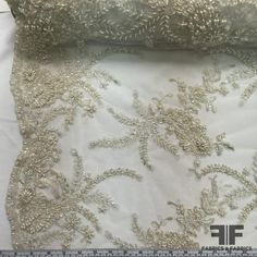 the fabric is white with silver flowers on it