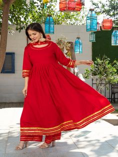 Royal Solid Red Round Neck Anarkali Waist Gathered Kurta Paired with Red Plazzo and Chanderi Dupatta Golden Work on it. Neck: Round Neck Sleeve Length: 3/4th Kurta Length: Ankle Length Work Type: Gota Patti Fabric: Kurta & Botton - Cotton Dupatta - Banarasi Chanderi Note: Dry Clean Only. The product will be shipped within 15-20 days of the order placed Measurements: Size Bust Waist Hip XS 34 28 36 Size 36 30 38 M 38 32 40 L 40 34 42 XL 42 36 44 2XL 44 38 46 3XL 46 40 48 4XL 48 42 50 5XL 50 44 52 Festive Red Kurta With Cutdana Detail, Red Anarkali Traditional Wear For Festive Occasions, Red Anarkali Set For Festive Season, Designer Red Kurta With Pallu, Red Straight Kurta Traditional Wear For Festive Occasions, Red Straight Kurta For Festive Traditional Wear, Red Straight Kurta For Festive Occasions, Red Semi-stitched Anarkali Set For Festive Occasions, Red Traditional Wear For Designer Diwali