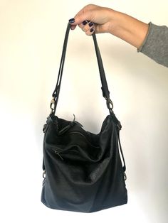 "The Donos Convertible bag - backpack in one simple movement has arrived! Beautiful shoulder bag, easily converted into a useful backpack (no need to make any arrangement in the handles), made in a gorgeous buttery soft and thick black leather. It's quite big, it can fit many things, the bag will adapt very easily to whatever you need to carry, even your 13\" laptop, water bottle, umbrella, wallet, cosmetic bags, etc.. Top zipper to keep it safe. It also has a zippered outside pocket in one side Versatile Leather Backpack With Removable Pouch For Daily Use, Versatile Leather Backpack With Double Handle, Versatile Soft Leather Backpack, Everyday Use Backpack With Double Handle And Soft Leather, Versatile Leather Backpack With Detachable Handle For Daily Use, Everyday Use Soft Leather Backpack With Double Handle, Soft Leather Backpack With Double Handle For Everyday Use, Everyday Versatile Leather Backpack With Adjustable Strap, Versatile Crossbody Backpack