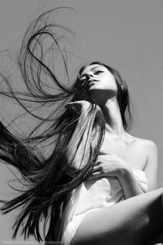 a woman with her hair blowing in the wind