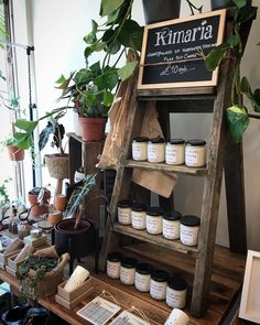 a shelf filled with lots of different types of items on top of a wooden table