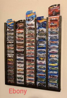 a wall mounted display case filled with hot wheels cars