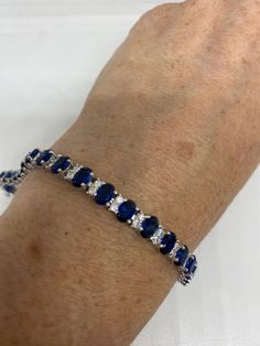 Vintage Blue Crystal Cubic Zirconia Bracelet Sterling Silver Tennis Blue Cubic Zirconia Bracelet Gift, Classic Sapphire-colored Cubic Zirconia Bracelets, Blue Sapphire Bracelets For Anniversary, Classic Blue Cubic Zirconia Jewelry, Luxury Blue Cubic Zirconia Bracelets, Classic Blue Bracelet Jewelry, Blue Fine Jewelry Tennis Bracelet, Aaa Quality Sapphire Jewelry For Gift, Oval Sapphire Bracelets As Gift