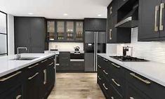 a kitchen with black cabinets and white counter tops