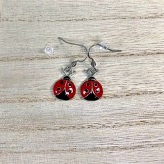 Red and Black Ladybug Charms on Surgical Stainless Steel ear wires All hook style earrings come with Silicone stoppers Measures:  just over 1/2 inch long and just under 1/2 inch wide  Enamel Zinc Alloy Charms are lead, cadmium and nickel free! Comes in small gift box Ships in 1 to 3 days, Orders over $35 ship free within the USA! To see what else I offer: https://www.etsy.com/shop/treasures2cherish Adjustable Enamel Earrings With Ear Wire, Red Enamel Dangle Earrings, Red Metal Earrings, Red Hypoallergenic Metal Jewelry, Hypoallergenic Red Metal Jewelry, Hypoallergenic Red Metal Earrings, Ladybug Accessories, Ladybug Earrings, Black Ladybug