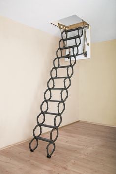 a ladder made out of metal links in the middle of a room with wood flooring