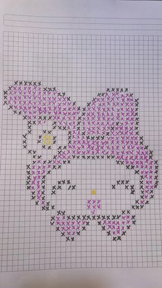 a cross - stitch hello kitty is shown on a piece of paper with pink and black dots