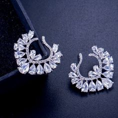 A unique pair of bridal earrings with an incredible sparkle! Adorned with flawlessly faceted cubic zirconia that capture the light from every angle with a perfectly translucent appeal, the earrings are rhodium plated for a bright finish which enhances the intricate detailing and conveys a modern take on old elegance. Overall length of the earring is 1.2" (approx. 3cm). Width: 1" (approx. 2.5cm). Weight: 8.6g. Hypoallergenic - lead, nickel and cadmium free. This exquisite design will add a touch Luxury Sparkling Cubic Zirconia Bridal Earrings, Intricate Dangle Bridal Earrings With Cubic Zirconia, Intricate Cubic Zirconia Dangle Bridal Earrings, Intricate Cubic Zirconia Chandelier Drop Earrings, Silver Cubic Zirconia Diamond Earrings, Glamorous, Cubic Zirconia Bridal Earrings, Girl Best Friend, Silver Wedding Jewelry, Heart Stud Earrings