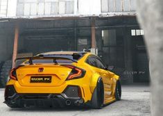 the rear end of a yellow sports car