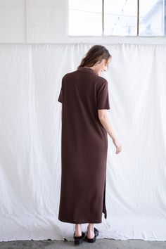 Vertical ribbed maxi dress with side slits and a button collar. - Sizing: Model is 5'8", wearing a size S - Content: 72% Polyester, 23% Rayon, 5% Spandex Care: Handwash recommended Imported Midi Length Loungewear Dress With Side Slits, Longline Loungewear Dress With Side Slits, Longline Lounge Dress With Side Slits, Loungewear Midi Dress With Side Slits, Ribbed Maxi Dress For Work, Solid Maxi Dress With Side Slits And Split Hem, Daywear Longline Maxi Dress, Chic Collared Ribbed Dress, Midi Maxi Dress With Side Slits For Daywear