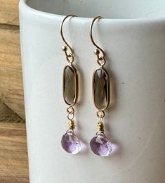 "A pair of pretty pink amethyst and green glass dangle earrings. A definite boho vibe with Sundance style and design. Wear them this spring - or any time you want a look of femininity and serenity. Gorgeous super parkly pink amethyst heart-shaped drops are wire wrapped in the very trendy \"messy\" style and suspended from bezel set green glass connectors. Gold French ear wires which I created from gold plated over copper ball head pins secure both earring assemblages. Overall earring length is a Purple Long Drop Earrings With Ear Wire, Nickel-free Purple Briolette Earrings, Purple Long Drop Jewelry With Ear Wire, Handmade Lavender Crystal Drop Earrings, Purple Long Drop Earrings As Gift, Nickel-free Lavender Drop Earrings, Gold Amethyst Long Drop Earrings, Lavender Briolette Earrings For Gift, Purple Drop Earrings With Ear Wire