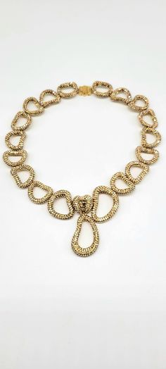 "Atelier Swarovski Necklace, Swarovski Crystal Statement Necklace, Gold Pave Necklace, Statement Collar Necklace, Champagne Crystal Necklace Measurements: 15\"L, 1.5\"W, Drop is 2.25\"L Metal: Gold Tone Findings: Snap Closure with press in sides to release Finish: Polished EXCELLENT CONDITION So, I have a confession to make. I debated posting this piece for a long time because I am SO IN LOVE with this magnificent work of art. Atelier Swarovski, the luxury side of the Swarovski Brand, makes the most unique, jaw-dropping and breathtaking pieces of crystal costume jewelry I have ever seen. Each piece is so sparkly, so well made, and so impressive that it looks like it is made of real diamonds and gemstones. Imagine the cost of a piece like this in diamonds. Thousands if not hundreds of thous Luxury Gold-tone Diamond Necklace, Luxury Yellow Gold Bridal Necklace For Party, Luxury Sparkling Jewelry For Evening, Luxury Crystal Rhinestone Necklace With Sparkling Stones, Formal Fine Jewelry Necklaces With Bling, Formal Bling Fine Jewelry Necklaces, Elegant Pendant Rhinestone Necklace For Party, Elegant Rhinestone Pendant Necklace For Party, Sparkling Fine Jewelry Necklace For Party