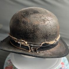 an old hat is sitting on top of a mannequin's head