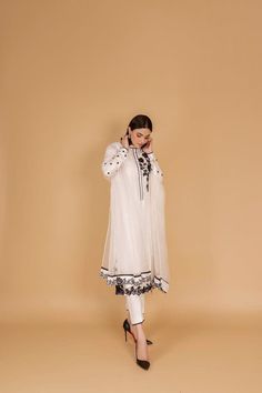 Introducing our sophisticated off-white silk kurta pant set, a timeless ensemble that seamlessly blends traditional elegance with contemporary style. Crafted with care, this outfit is perfect for occasions that demand grace and poise. The off-white silk kurta features a classic silhouette, providing both comfort and style. The intricate embellishments in black resham thread add a touch of sophistication, creating a beautiful contrast against the serene backdrop of the fabric. The careful detailing showcases skilled craftsmanship, making this ensemble a true work of art. Paired with the kurta are comfortable and chic pants, completing the look with a modern twist. The flowing silhouette of the pants enhances the overall grace of the outfit, making it suitable for various occasions. To eleva White Anarkali Palazzo Set, Traditional Off White Palazzo Set For Eid, Traditional Off-white Palazzo Set For Eid, Designer Off White Palazzo Set For Eid, Elegant Off White Salwar Kameez For Navratri, Designer White Palazzo Set With Dupatta, Elegant Off White Palazzo Set With Traditional Drape, White Long Sleeve Palazzo Set For Navratri, Elegant Off White Palazzo Set For Festive Season