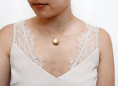 "A simple and classic hammered coin necklace with a pendant that hovers over delicate cable chain for a modern sleek look. Perfect for everyday. Tumbled for hours to achieve a satin finish. MATERIALS tarnish resistant rhodium silver/22k gold plated brass DIMENSIONS 22mm (7/8\") diameter, hung on an 16\" chain with 2\" extension. ◊ Matching hammered jewelry: https://www.etsy.com/shop/kindlingandco/search?search_query=hammered ◊ Visit our shop: https://www.etsy.com/shop/kindlingandco ✨SHOP POLICIE Hammered Jewelry, Pendant Minimalist, Jewelry Card, Coin Necklace, Circle Pendant, Sleek Look, 22k Gold, Minimalist Style, Cable Chain