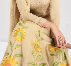 COLOR : Dull Yellow Cream FABRIC : Gown & Dupatta - Premium Silk WORK : Resham Embroidery, Hand Work, Sequins, Floral Motifs, Lace Border OCCASION : Wedding, Reception, Mehendi, Party Wear, Festival READY-TO-WEAR : No STITCHING : Available as semi-stitched fabric, can be stitched using standard size option (+$30). Note: There might be a slight color variation due to lighting and flash used during photoshoot. The bright shade seen is the best closer view of fabric's color. Silk Anarkali Gown, Mehendi Party, Cream Gown, Embroidery Hand Work, Resham Embroidery, Silk Anarkali, Gown Party Wear, Party Wear Gown, Embroidery Hand