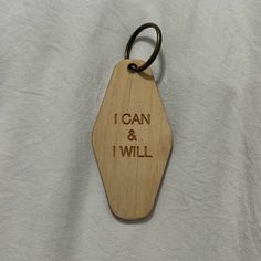 a wooden keychain with the words i can and i will engraved on it