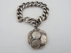 "Tantalizing vintage Napier charm bracelet. It is the kind of piece a world traveler would buy on one of their many excursions. I adore this Napier piece. It is not the \"norm\" in Napier charm bracelets. It is both simple and incredible. The single charm is designed to mimic foreign coins from Mexico and France. The detail on the coins is truly unique. The bracelet holding the charm is significant. The links are large, which helps balance the design element of the charm. Condition is good. One Foreign Coins, Napier Jewelry, World Traveler, Vintage Costume Jewelry, Vintage Costumes, Design Element, Charm Bracelets, Costume Jewelry, Jewelry Bracelets