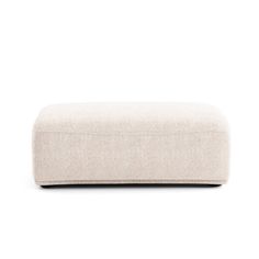 the footstool is made out of fabric and has a white cushion on it