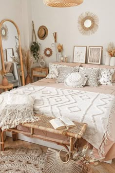 a bed room with a neatly made bed and lots of mirrors on the wall above it