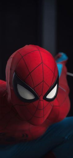 the spider - man is looking at something with eyes wide open and his head turned to look like he's about to fall