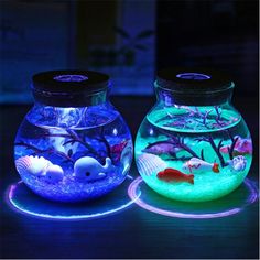 two glass fish bowls with different colored lights in them