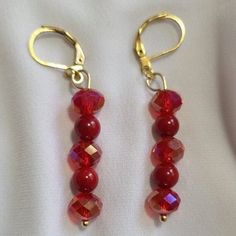 Two Red Coral Gemstone Beads and Three Red Faceted Glass Beads with Gold Tone Lever Backs. Handmade Red Czech Glass Beaded Earrings, Elegant Red Czech Glass Earrings, Red Dangle Jewelry With Faceted Beads, Red Czech Glass Beaded Earrings With Dangling Beads, Red Beaded Crystal Drop Earrings, Red Beaded Drop Crystal Earrings, Red Beaded Czech Glass Earrings, Red Handmade Dangle Crystal Earrings, Red Czech Glass Earrings With Dangling Beads