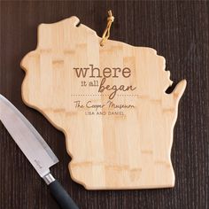 a cutting board with a knife on top of it that says where it all begins