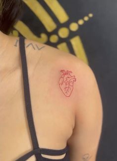 a heart tattoo on the back of a woman's left shoulder and upper arm