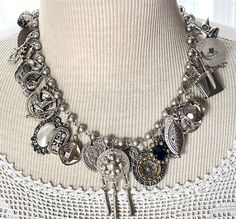 From a once loved, large collection of vintage jewelry, including necklaces, bracelets and earrings, I have gleaned all these silvery components to create a stunning assemblage necklace.    This is a fully loaded collection of interesting components that have a lovely weight and sound.  The silvery-gray pearlized glass bead chain is 18" long. I work with vintage and antique parts. Some may show some signs of wear or age. Please look at the pictures carefully, and contact me before purchasing if you have any questions. I can send additional pictures if you prefer. I like to think that older items possess a character that newer items have not yet earned. Unique Silver Necklaces From Vintage Collection, Vintage Sterling Silver Necklace With Jewels, Antique Silver Costume Jewelry, Unique Silver Vintage Necklace, Elegant Antique Silver Jewelry With Charms, Vintage Antique Silver Dangle Jewelry, Antique Silver Vintage Jewelry With Charm, Vintage Silver Necklace With Jewels, Antique Silver Vintage Dangle Jewelry