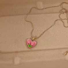 Trendy Pink tulip flower heart shaped pendant charm necklace, 14K real gold plated chain. Crafted from high-quality materials, this stunning necklace features a delicate heart-shaped pendant adorned with a beautiful pink tulip motif, symbolizing love, beauty, and new beginnings. Cute girly aesthetic, y2k layering necklace choker. Exquisite statement necklace to elevate your fashion style. 💎 Features: ♥ Handmade jewelry ♥ Finish Tone: Finest 14K gold plated | Pink ♥ Approximate Measurements: - L Pink Clavicle Chain Necklace For Valentine's Day, Pink Heart Charm Necklace With Heart Pendant, Pink Heart Pendant Clavicle Necklace, Cute Rose Gold Heart Necklaces, Cute Rose Gold Heart Necklace, Pink Heart Pendant Necklace With Heart Charm, Pink Heart Necklace With Clavicle Chain For Valentine's Day, Pink Dainty Heart Necklace For Mother's Day, Cute Rose Gold Heart Pendant Necklace