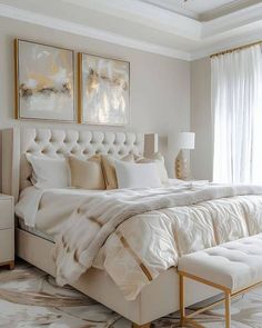 a large white bed sitting in a bedroom next to a window