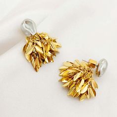 ✦ Discover the sophistication and versatility of our Gold Silver Tones Double Wear Leaf Fringe Earrings Set! These elegant earrings feature a silver pendant that can be worn as a stud or paired with a gold tassel for a stunning 2-piece set. The single abstract stud exudes cool minimalism, while the gold leaf sequin fringe adds a pop of artistic flair. Get ready to rock any look with these exclusive earrings. ----------- DETAILS----------- *Sold in Pair - Color: Gold - Size(Length* Width): 3.8cm Silver Dangle Clip-on Earrings Gold Plated, Silver Plated Drop Earrings Jewelry, Gold Pendant Metal Earrings, Gold Metal Pendant Earrings, Silver Plated Metal Earrings, Silver Gold-plated Clip-on Earrings For Anniversary, Silver-plated Metal Earrings, Silver Gold Plated Clip-on Earrings For Anniversary, Silver Plated Earrings As Gift