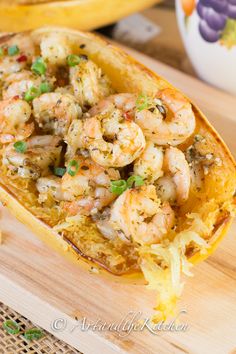 shrimp and grits in a yellow dish on a cutting board