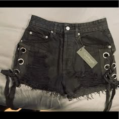 Black Denim, High Rise, Destructed, Lace Up Shorts. Never Worn. Tags Attached Edgy High Rise Fitted Jean Shorts, Edgy High-rise Fitted Jean Shorts, Edgy Cutoff Jean Shorts For Night Out, Black Distressed Punk Shorts, Edgy Short Jeans, Edgy Cropped Jeans For Night Out, Edgy Short Jeans For Night Out, Edgy Short Length Jeans For Night Out, Edgy Black High Rise Jean Shorts