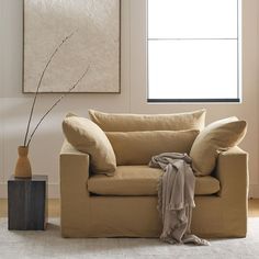 a living room with a couch, chair and vase