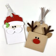 two christmas gift bags with santa and reindeer faces