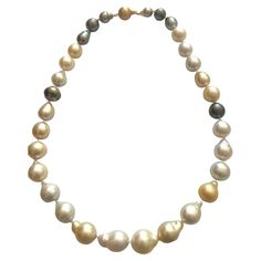 Estate Stunning Multicolor grey, silver, cream, and white undyed South Sea Baroque Pearls Necklace. 30 baroque pearls, each pearl is unique. The necklace is finished with a round 14k yellow gold ball clasp. The stunning necklace is 20 inches long. 30 South Sea Baroque Pearls: 20.5 x 15.6mm- 13.0 x 12.1mm. Baroque Pearls Necklace, Pearl Gold Necklace, Pearls Necklace, Gold Pearl Necklace, Sea Pearl, South Seas, South Sea Pearls, Sea Pearls, Stunning Necklace