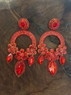 "These fun and stylish extra wide crystal rhinestone earrings are a great statement piece! Size of earrings: 2.25\" Wide  and 5.5\" Long.  Color: red Base metal: gold Style: pierced and clip on available! More colors available upon request, just message us! Looking for a matching bracelet? https://www.etsy.com/listing/1339552781/ https://www.etsy.com/listing/593906506/ https://www.etsy.com/listing/538148439/red-crystal-bracelet-large-crystal?ref=shop_home_active_33 Looking for the perfect pair of earrings for a special occasion. We specialize in custom work in fashion jewelry, pearls, and natural stones! Please feel free to browse through our other listings, and if you can't find what you are looking for just send us a message and will create the perfect piece for you. jewelry.desertrosede Red Glamorous Chandelier Earrings For Party, Glamorous Red Chandelier Earrings For Party, Red Crystal Dangle Earrings For Party, Red Glamorous Chandelier Earrings For Evening, Glamorous Red Chandelier Earrings For Evening, Red Jeweled Earrings For Evening, Glamorous Red Crystal Earrings For Evening, Red Bling Jewelry For Evening, Red Crystal Rhinestone Earrings For Party